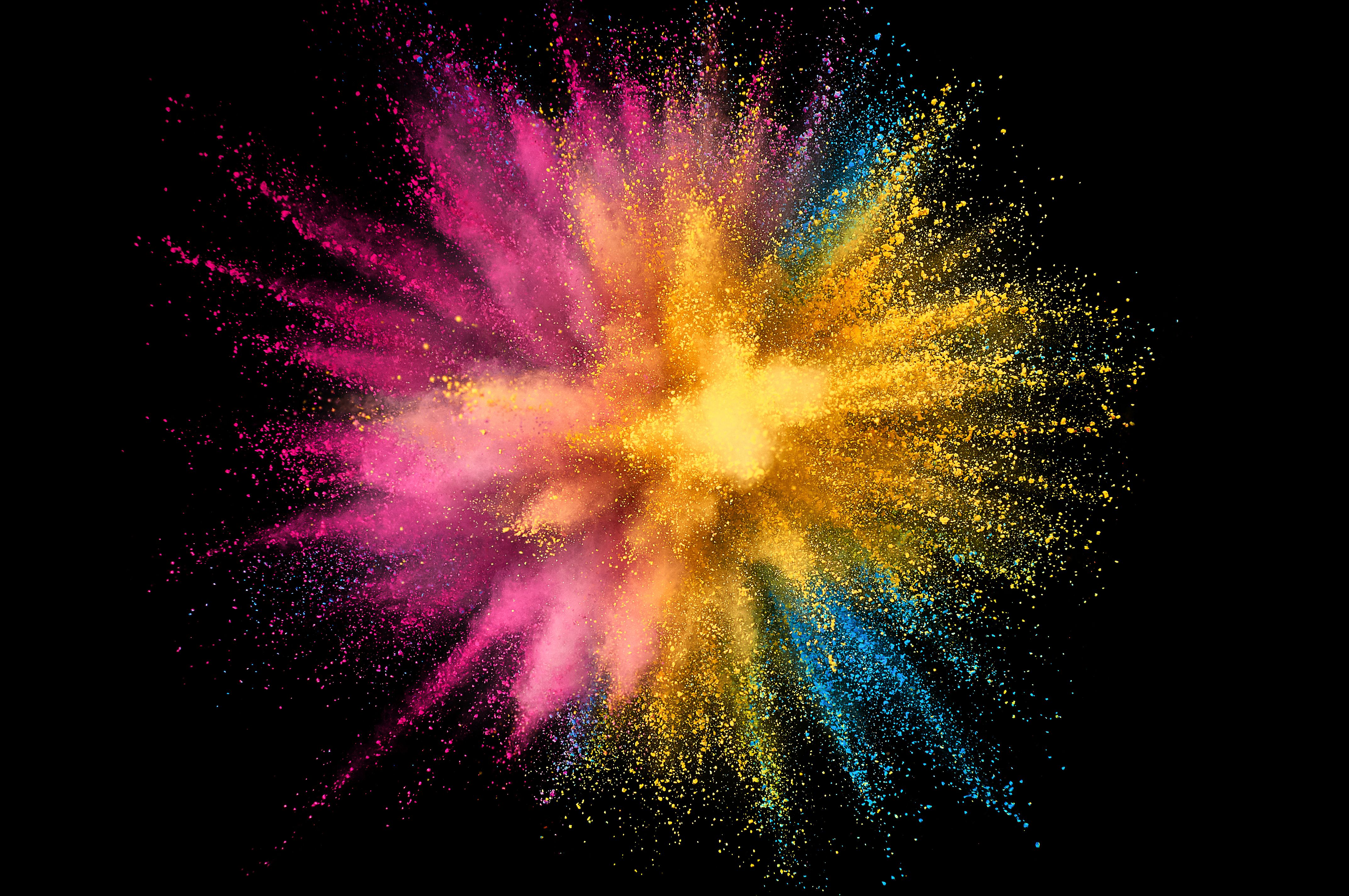Pink, orange, yellow, purple, and blue powder explosion to represent our powder coating services