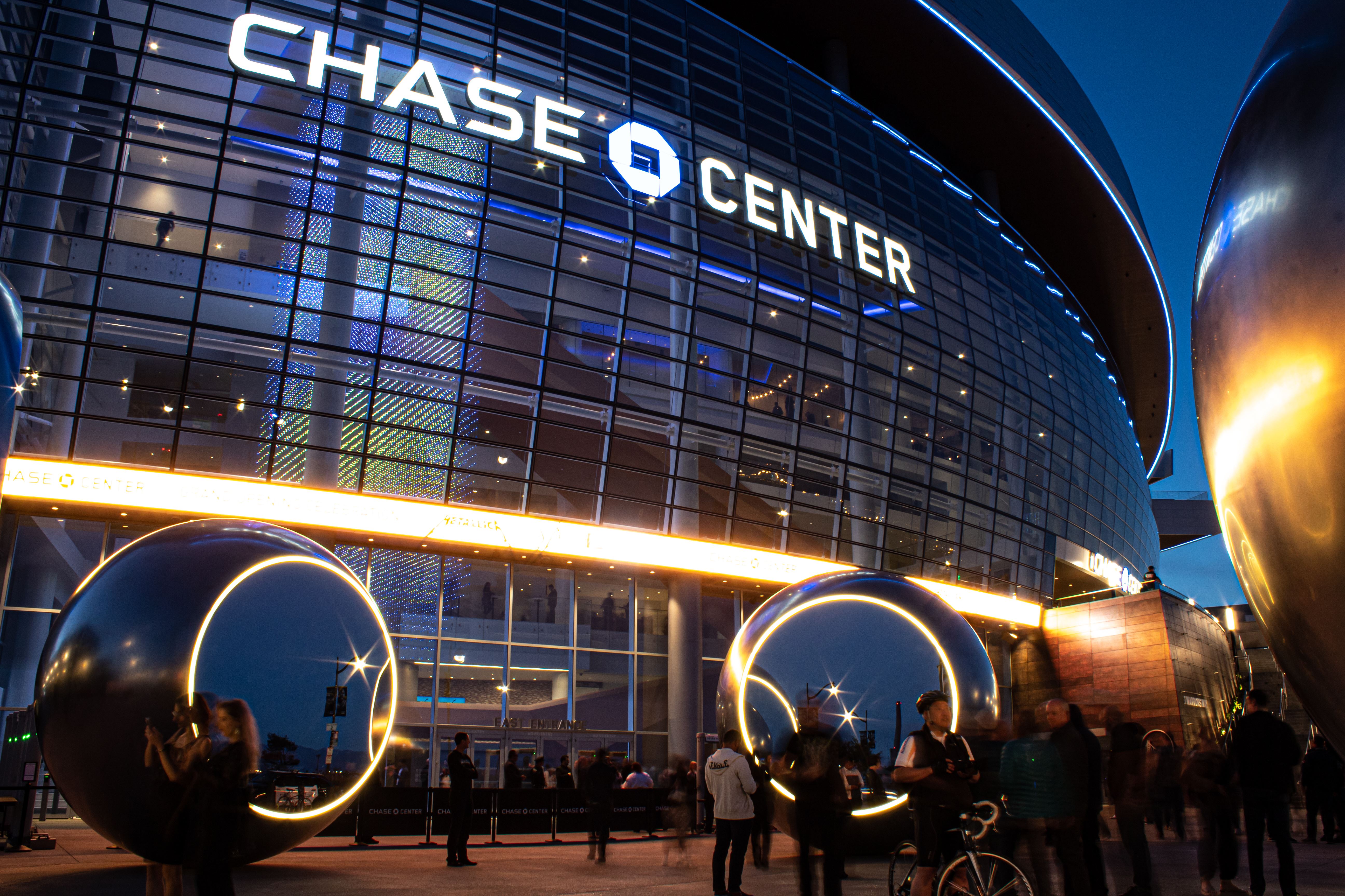 The exterior of Chase Center with a crowd of people outside 